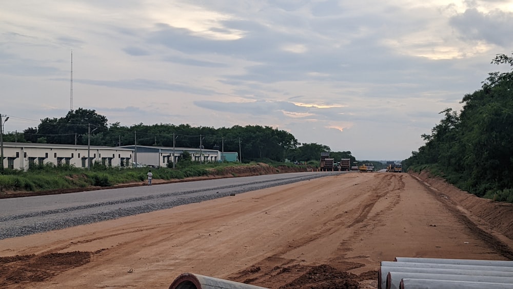 a dirt road with buildings on the side