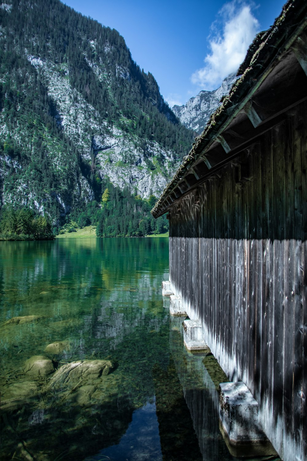 a wooden building next to a lake