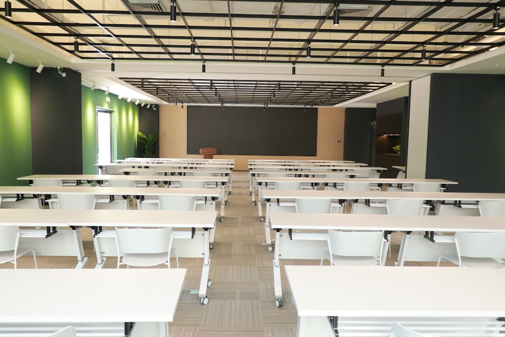 a room with white tables and chairs