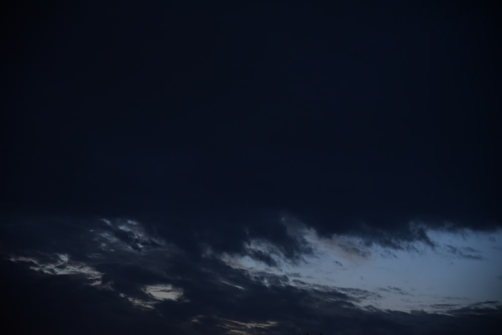 a dark sky with clouds