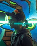 A vibrant urban mural backdrop with a Lumina Apparel hoodie catching the light.