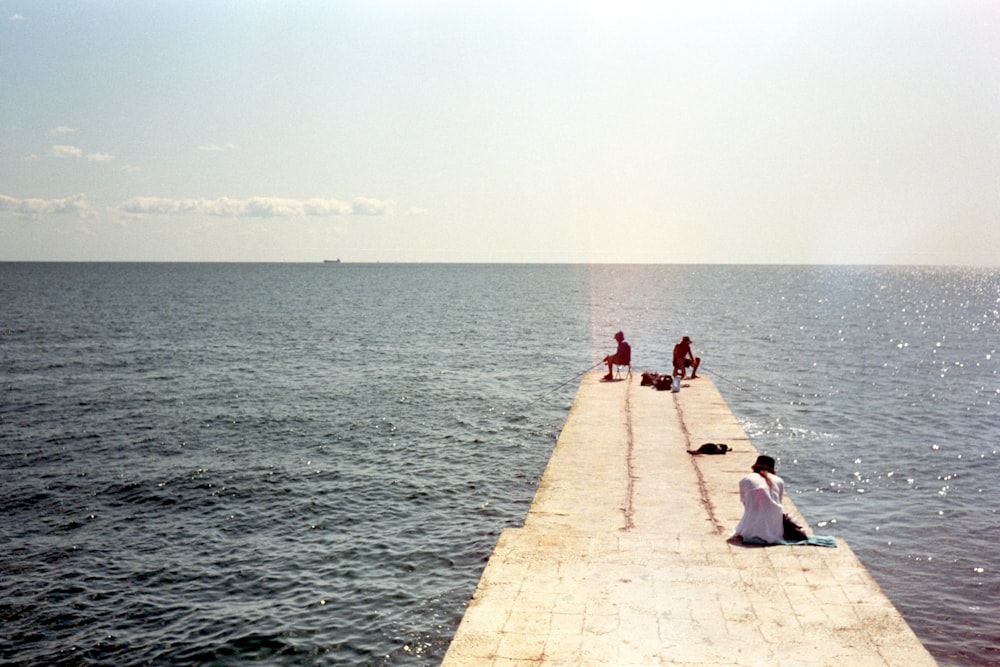 people sitting on a dock