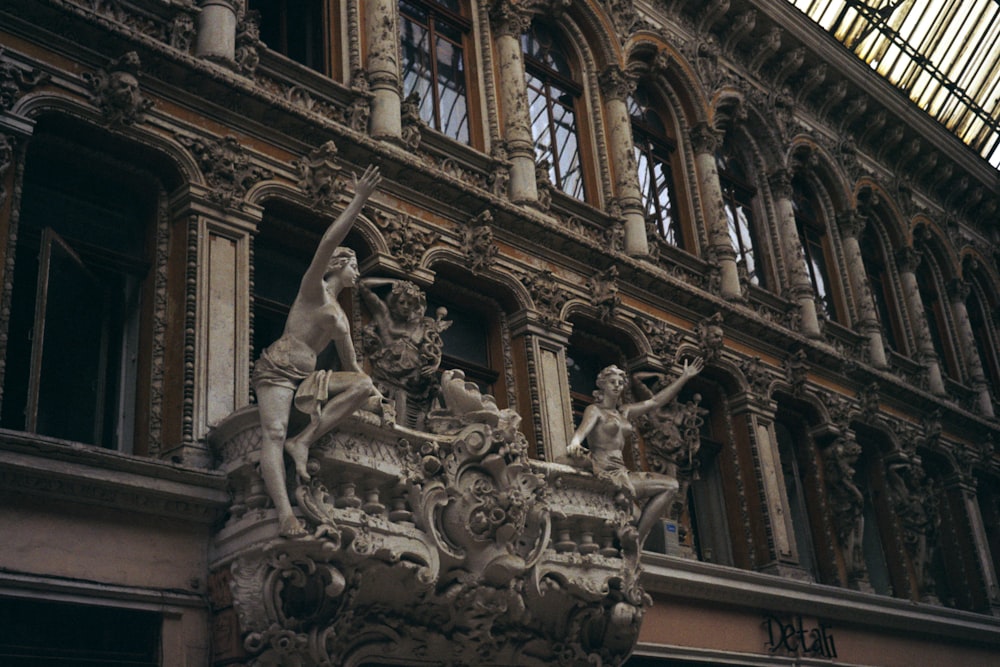 a building with statues and a large window