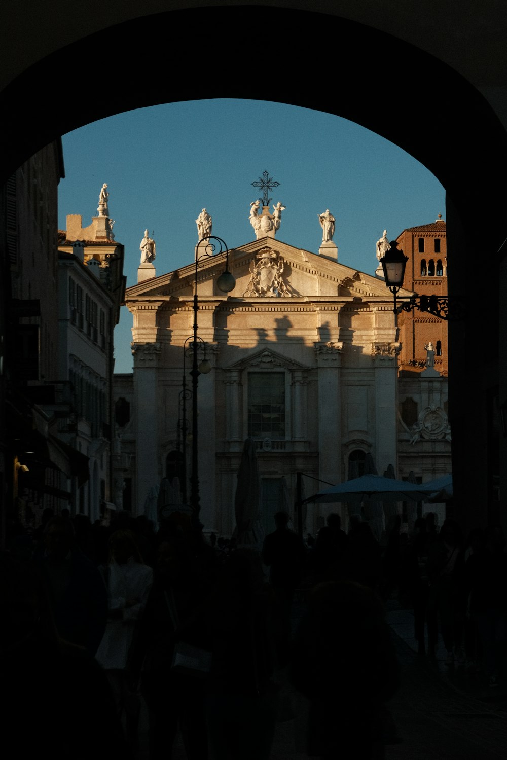 a group of people walking through a large archway