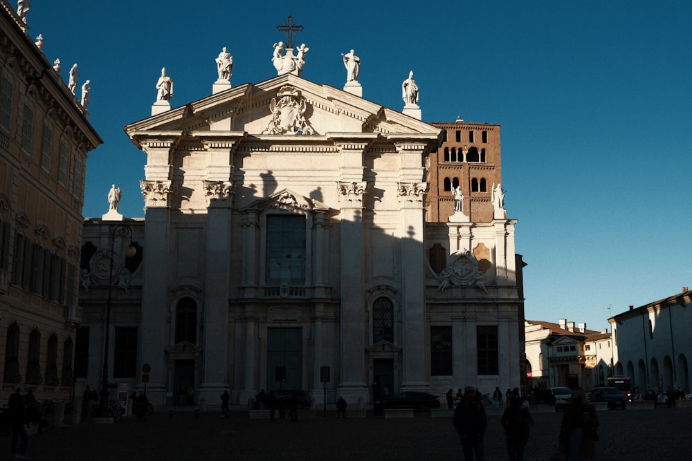 a large stone building with statues on top