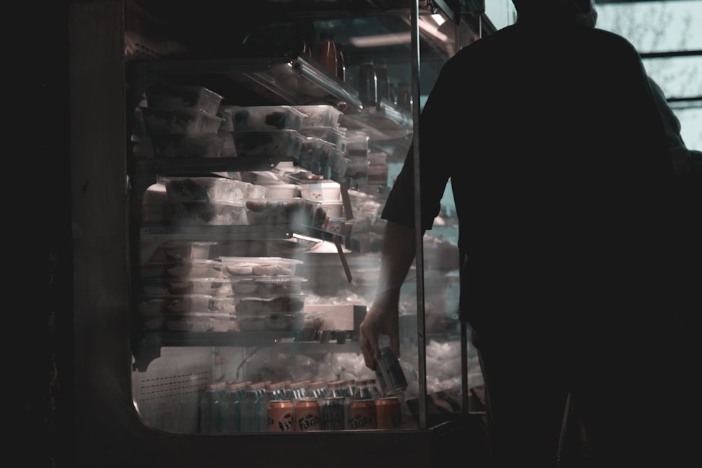 a man opening a refrigerator