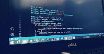 The screen displays a computer programming code editor with syntax highlighted in blue and white. The code appears to be written in PHP, focusing on handling file uploads, checking file size, and ensuring only specific file types are allowed. It includes logic for managing file extensions and size limits, and there is a visible error message for file size issues.
