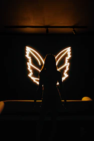 Wise mentor figure silhouette with neon accents, symbolizing guidance and insight.