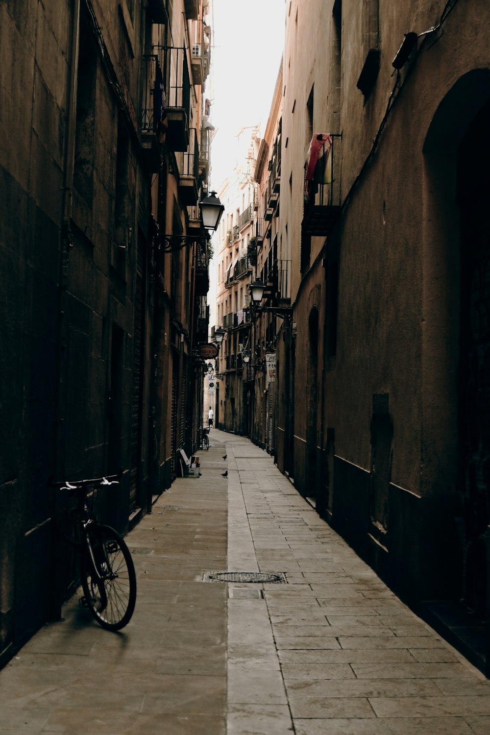 a bicycle parked on a narrow street