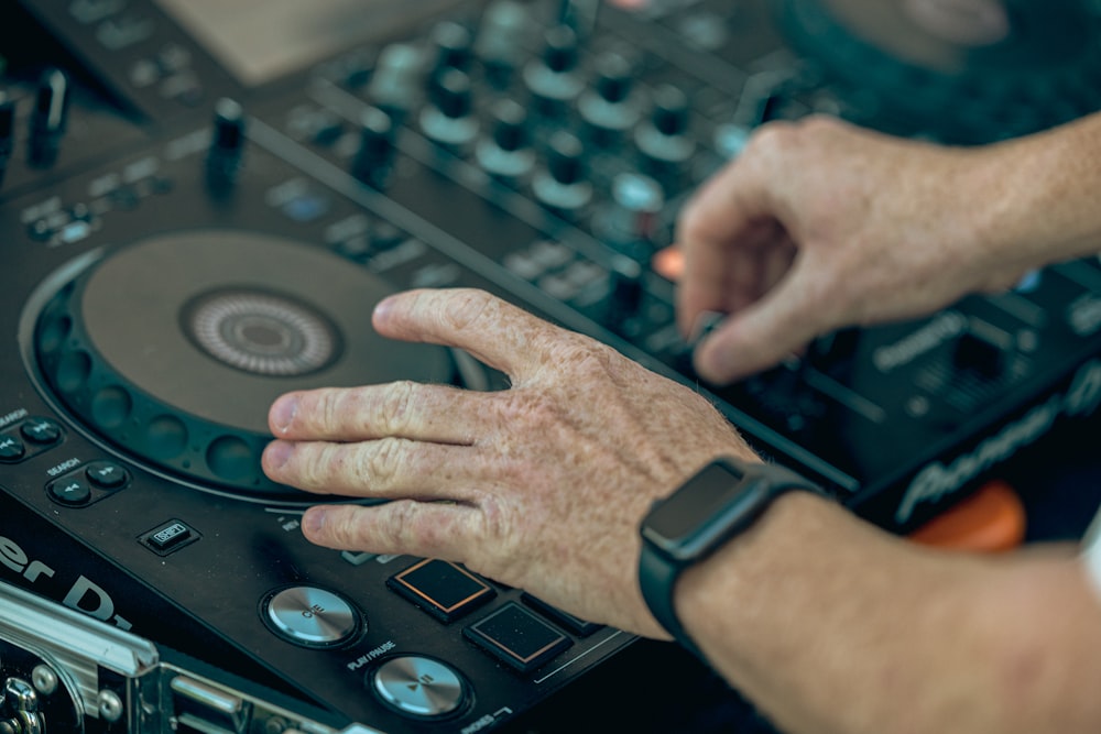 a close-up of hands on a control panel