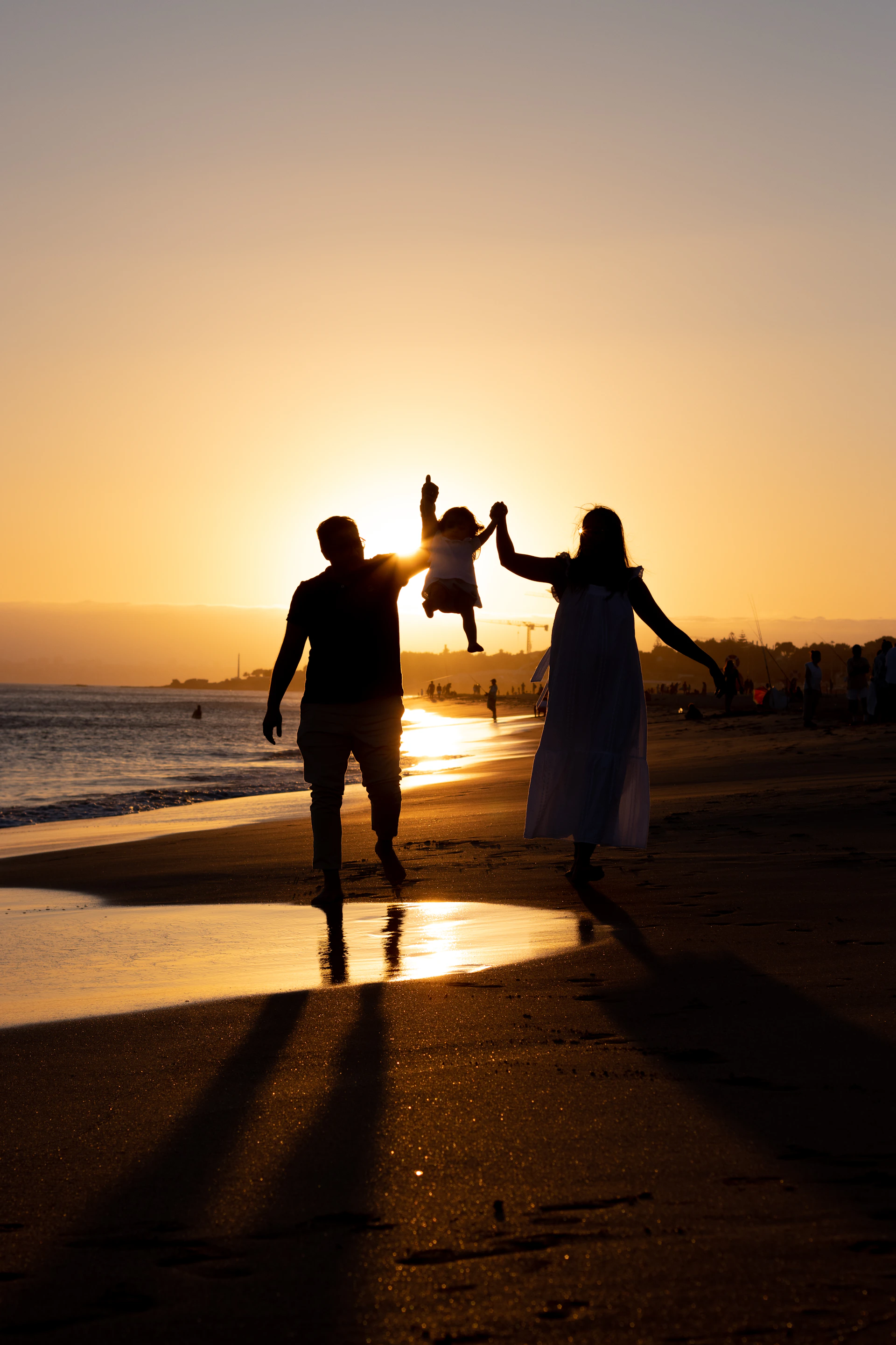 a man and woman holding hands on a beach