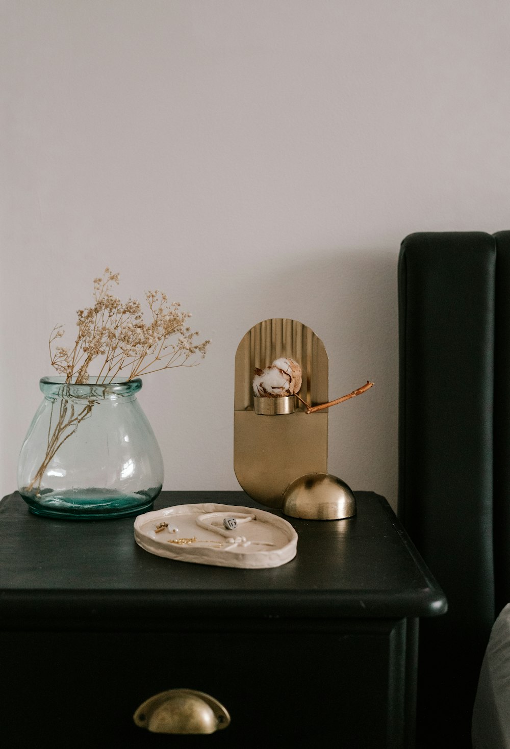 a table with a vase of flowers and a plate of food