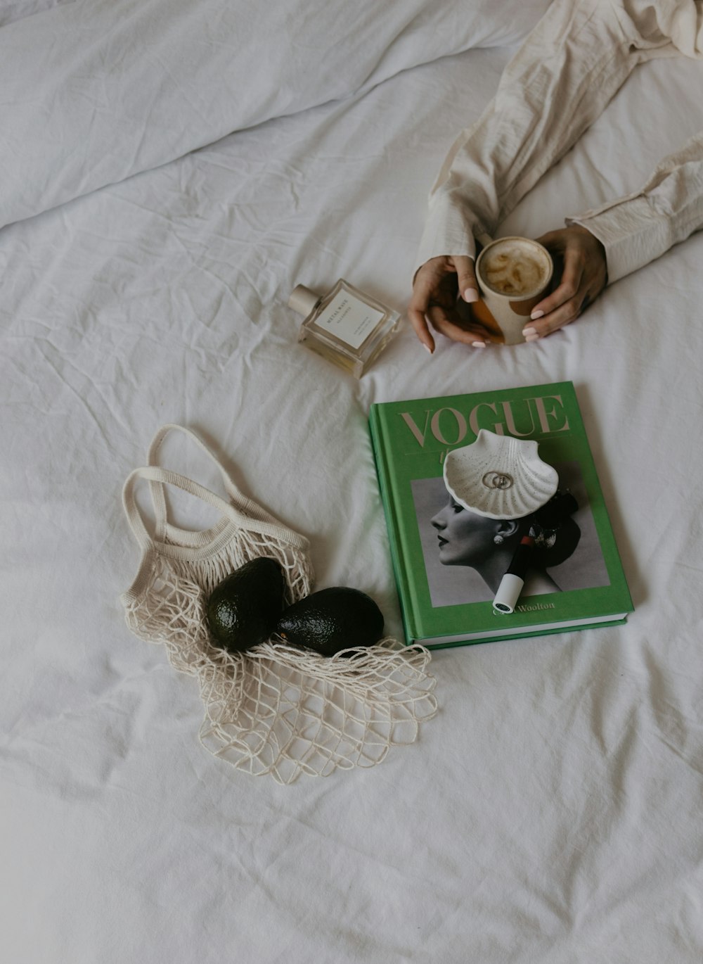 a book and a purse on a bed