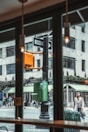 View from the window showing a lively city street with cafes and shops.