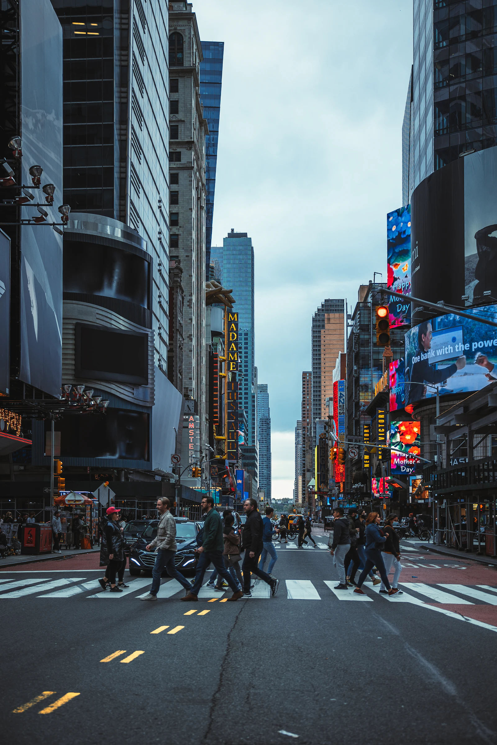 Pedestrians crossing a street in Times Square, New York