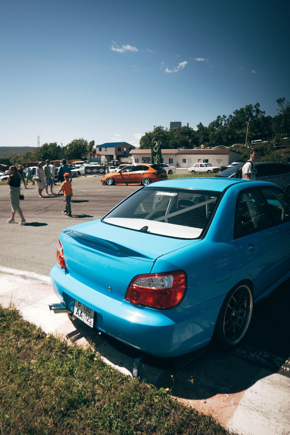 a blue car parked on the side of a road