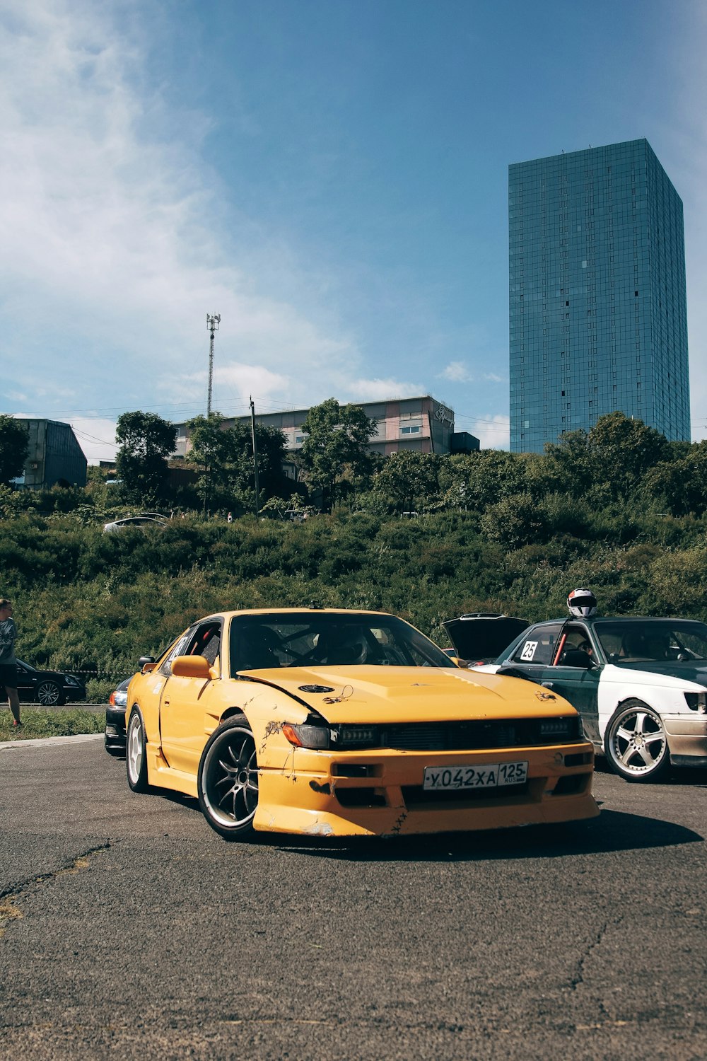 a yellow sports car parked in front of a building