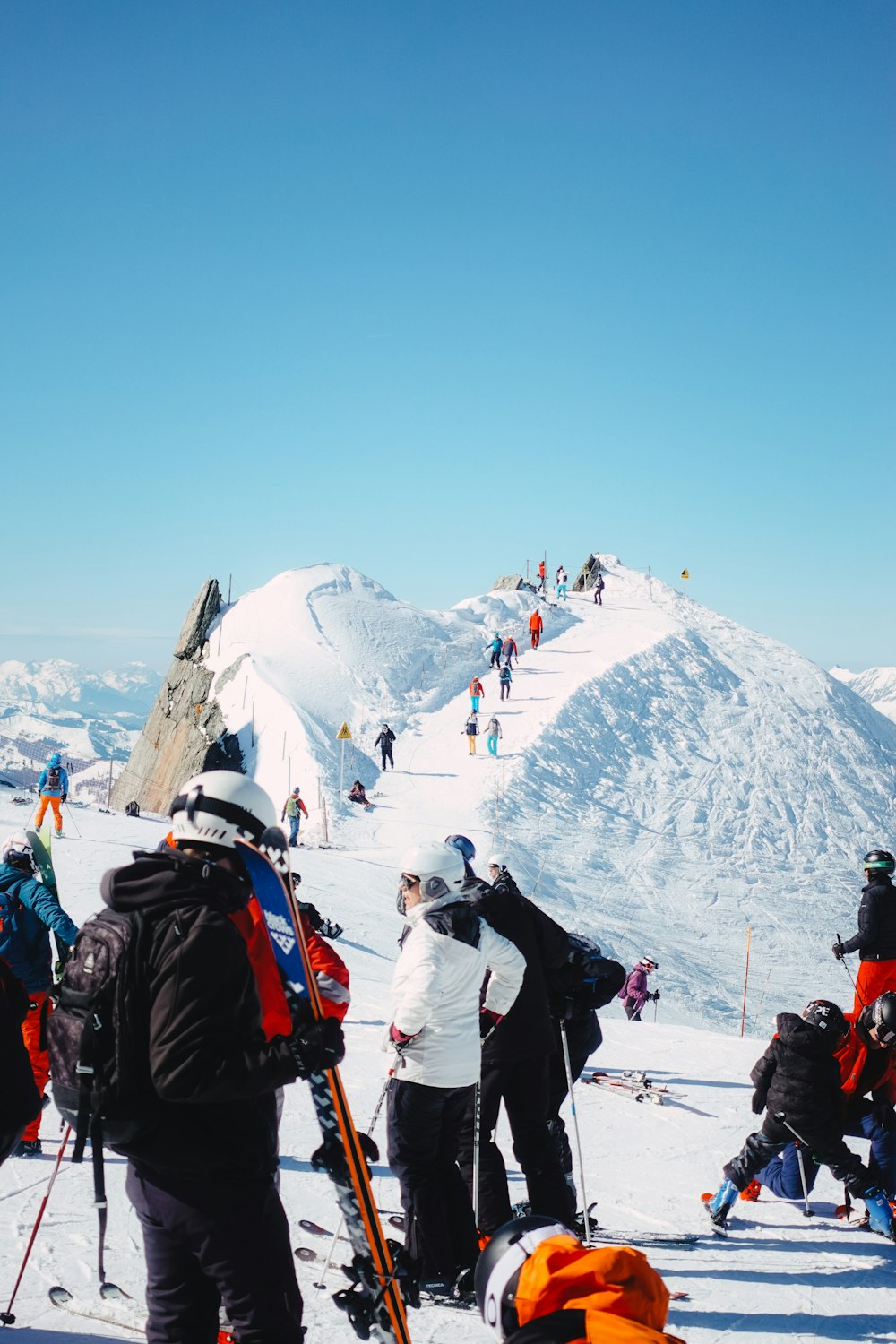 a group of skiers gather on a snowy mountain