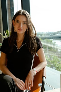 a woman sitting on a ledge