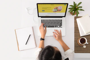 Personal branding photo of a businesswoman working on a laptop