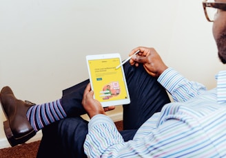 a man holding a tablet