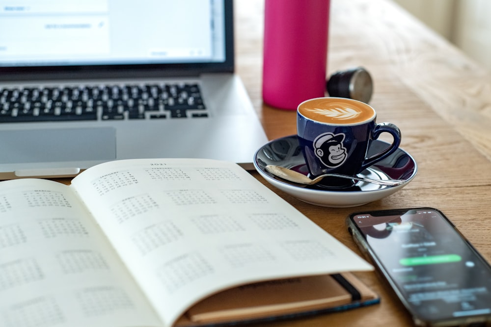 a coffee cup and a pen on a desk