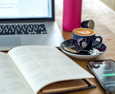 a coffee cup and a pen on a desk