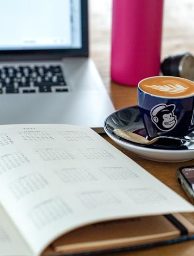 a coffee cup and a pen on a desk