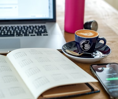 a coffee cup and a pen on a desk