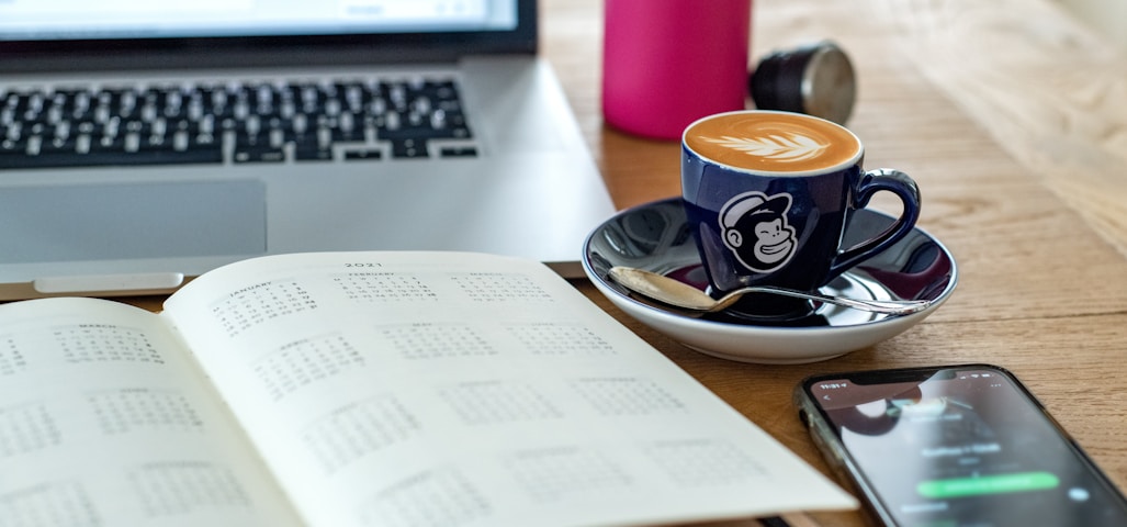 a coffee cup and a pen on a desk