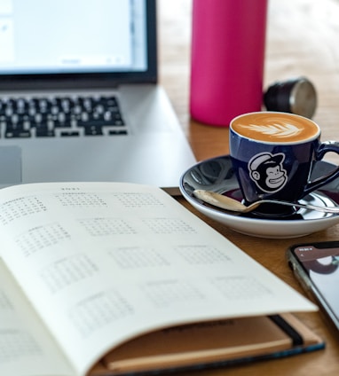 a coffee cup and a pen on a desk