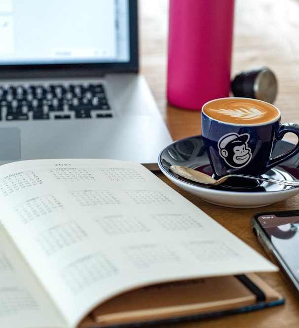 a coffee cup and a pen on a desk