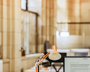 a desk with a lamp and a lamp on it