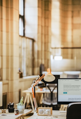 a desk with a lamp and a lamp on it