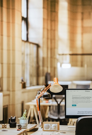 a desk with a lamp and a lamp on it