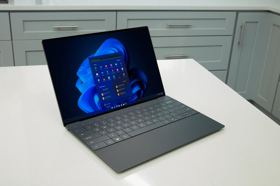 Laptop computer on a desk with its screen illuminated