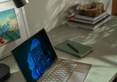 A sleek workspace with a laptop displaying a content calendar, bathed in soft Parisian light.