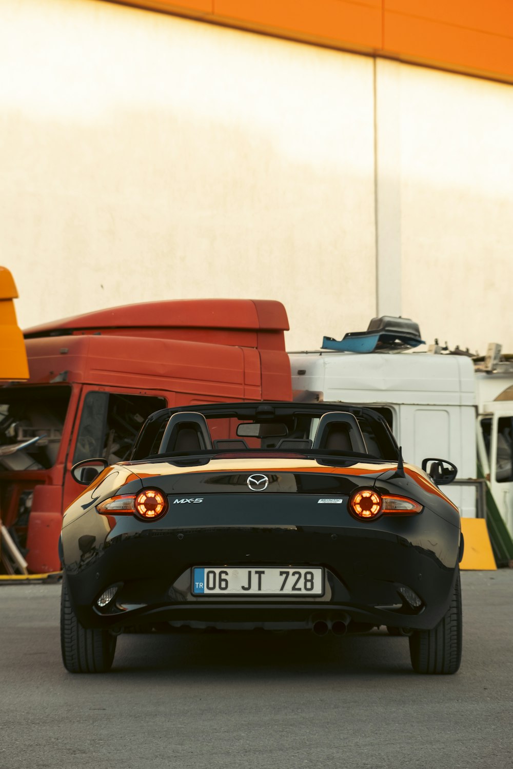 a black car with a red car behind it