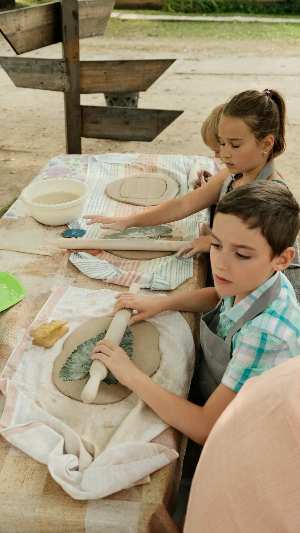 a boy and girl sitting at a table with food