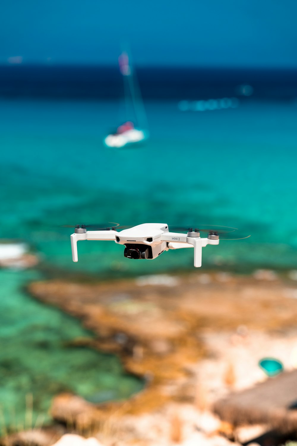 a drone flying over a beach