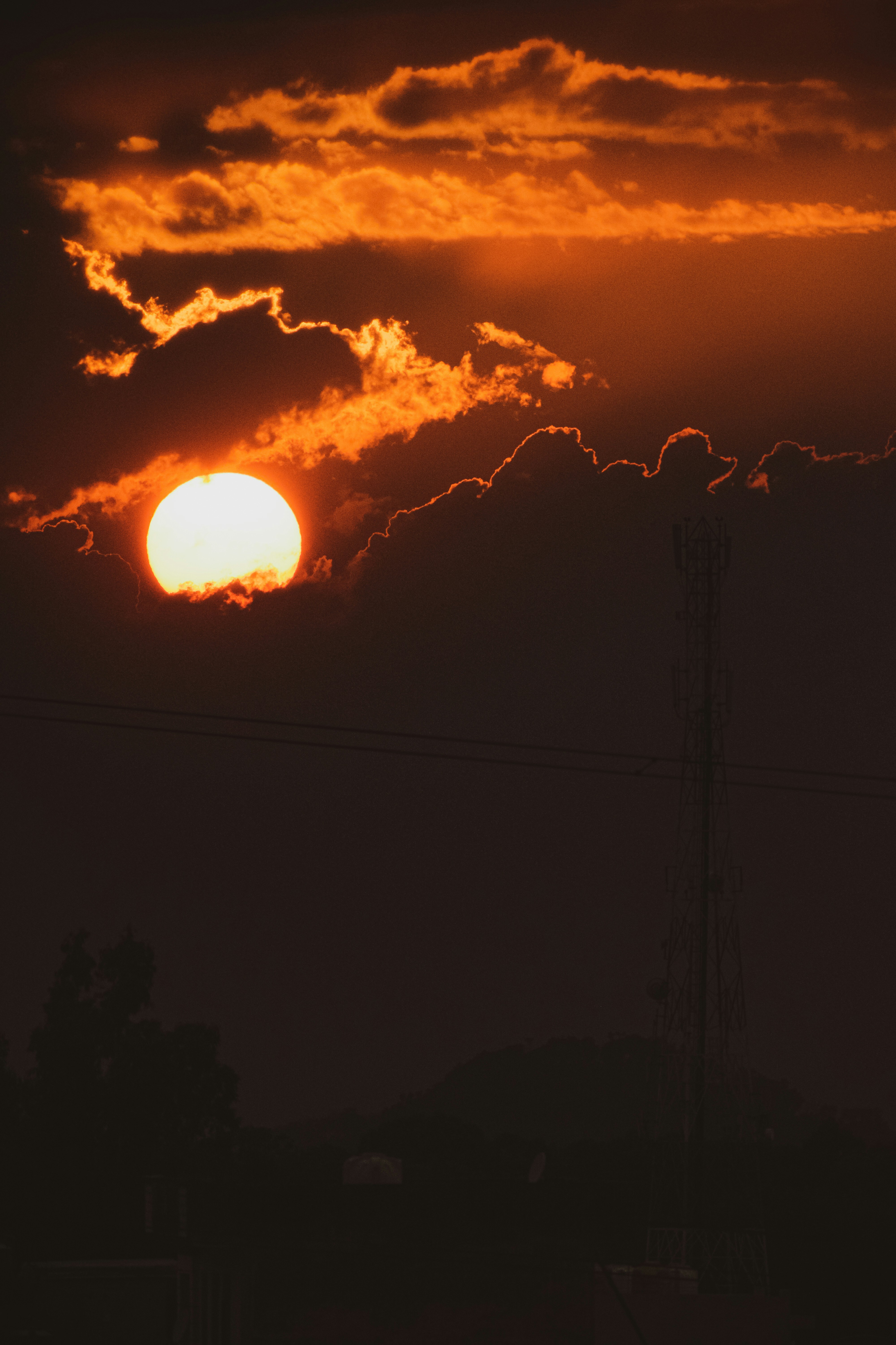 a sunset over power lines