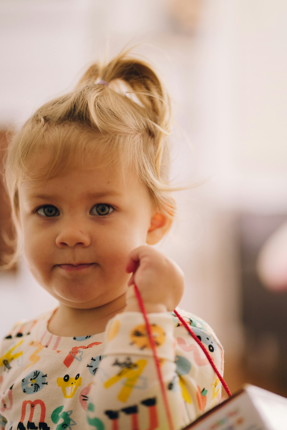 a baby holding a straw