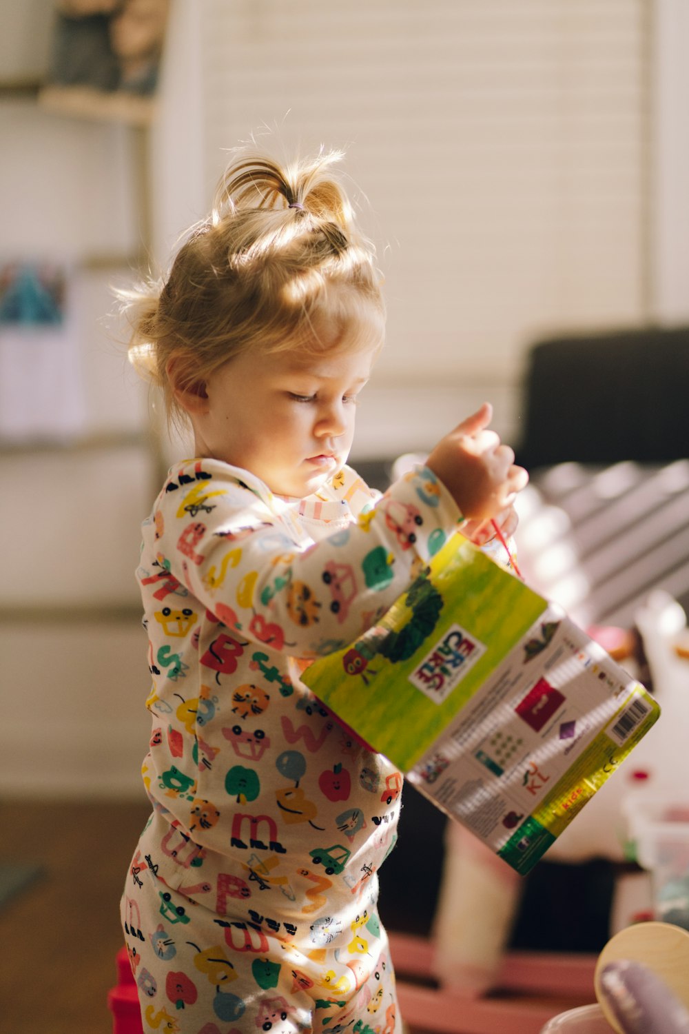 a little girl holding a bottle