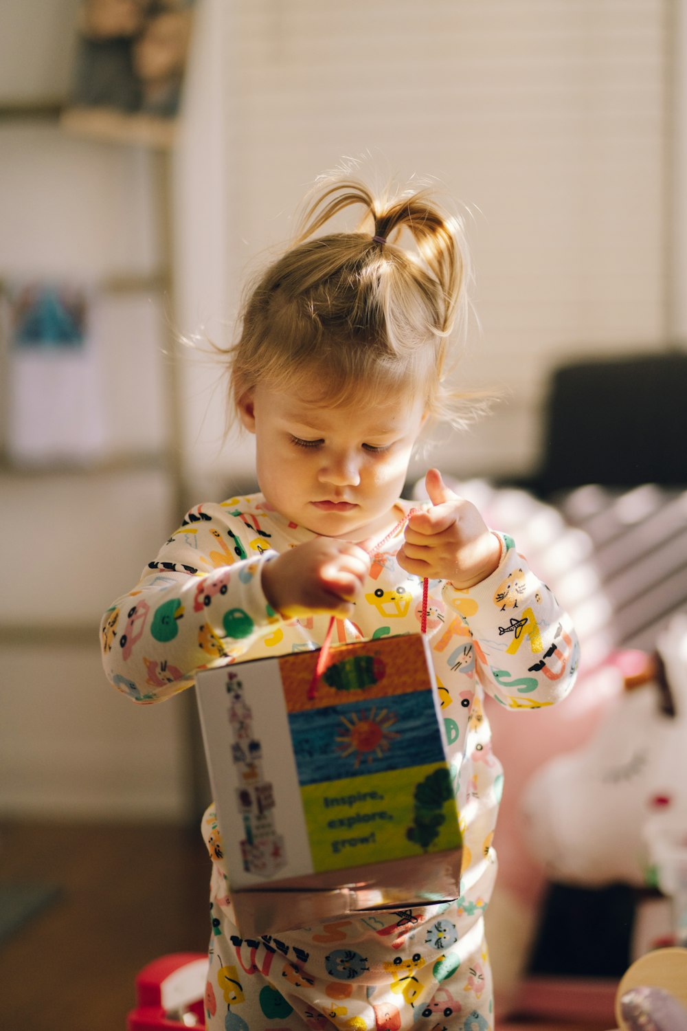 a little girl holding a book