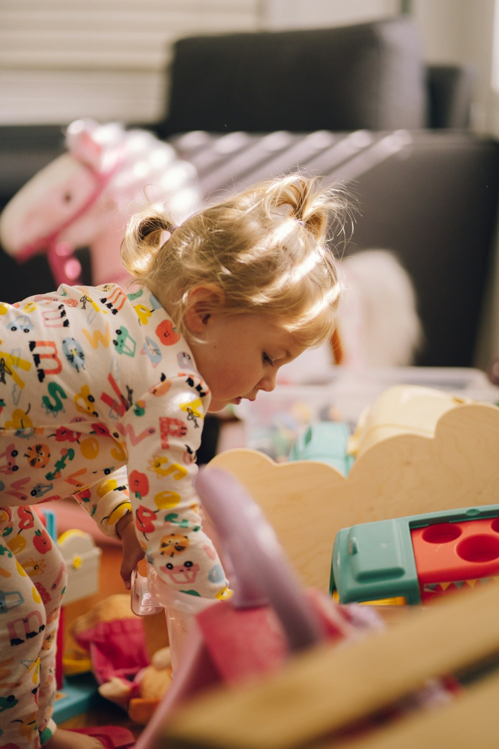 a little girl playing with a toy