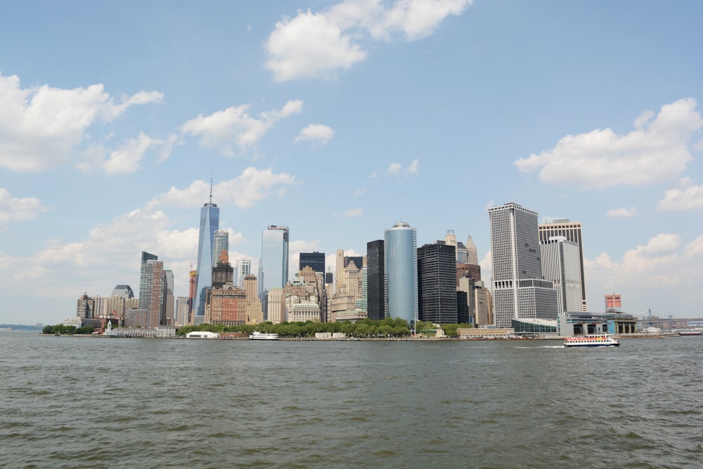 a city skyline with a body of water in the foreground