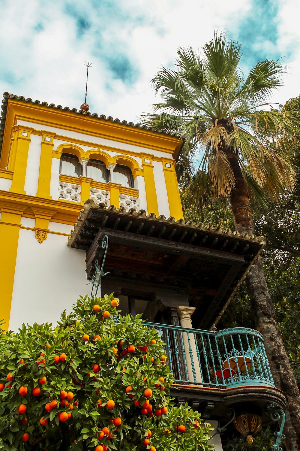 a building with palm trees and a fence around it