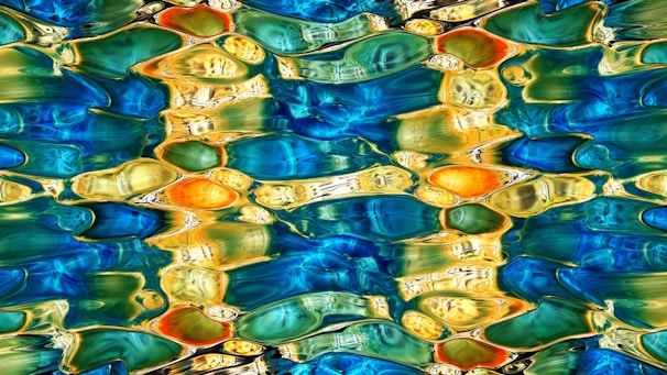 A swirling ripple of vibrant colors in water, symbolizing ideas in motion beneath the surface.