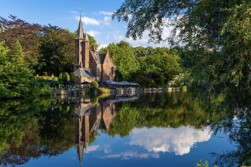 a body of water with trees and a building in the background