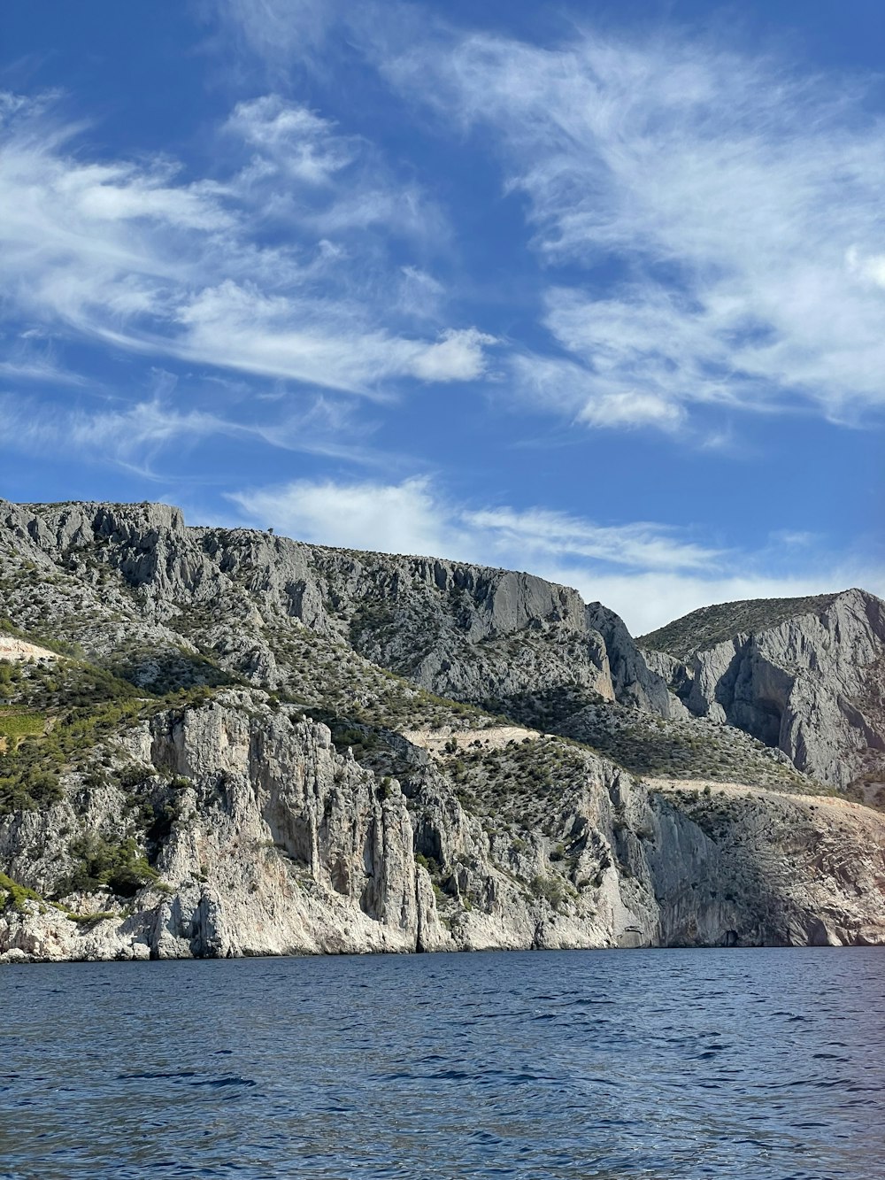 a cliff with a body of water below